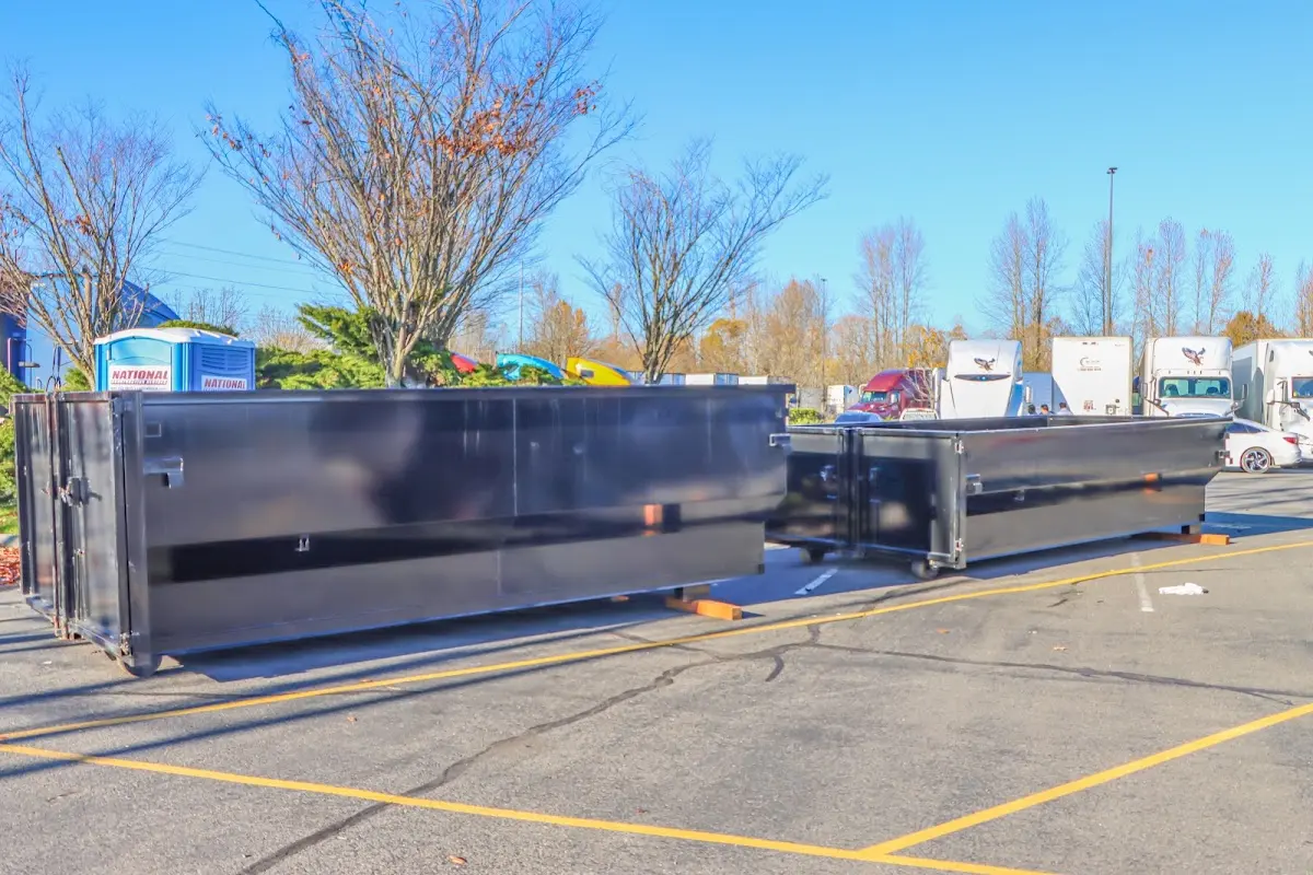 Professional dumpster rental service with roll-off container on residential driveway in Medina